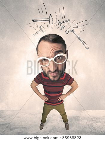 Funny person with big head and drawn punching hammers over it