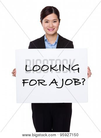 Businesswoman with white palcard for showing phrase of looking for a job