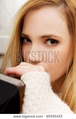 Young beautiful woman in depression, drinking alcohol.