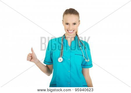 Beautiful smiling woman doctor with thumbs up.
