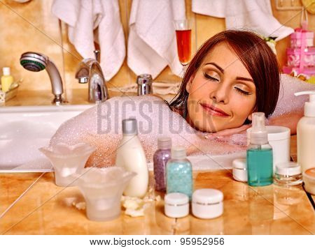 Woman relaxing and sleep at water in bubble bath.
