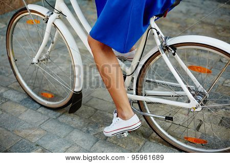 Leg of young female riding bicycle