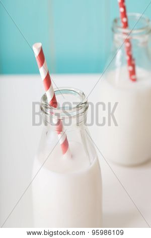 Two Milk Bottles With Red Colored Straw