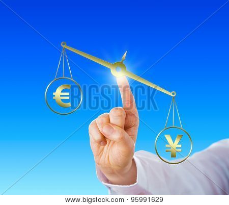 Yen Sign Outweighing The Euro On A Golden Scale