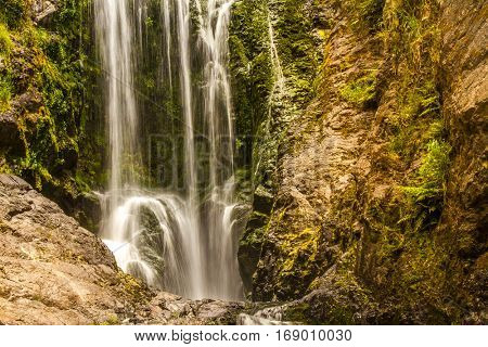 beautiful water fall in forest, new zealand, waipu, piroa falls