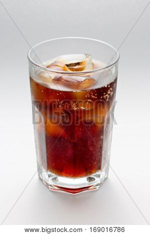Misted glass with a glass of Coke, Pepsi, rum, cocktai, alcohol ice cubes on a white background