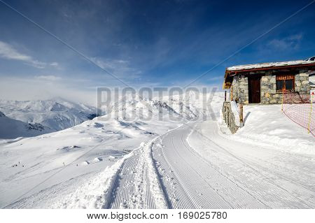 Alpine winter mountain landscape. French Alps covered with snow in sunny day. Val-d'Isere, France