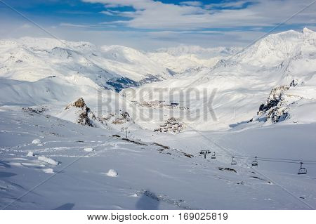 Alpine winter mountain landscape. French Alps covered with snow in sunny day. Val-d'Isere, France