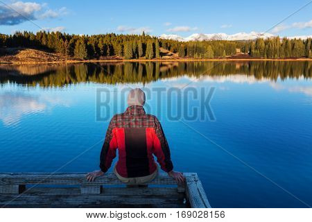 Man on mountains lake