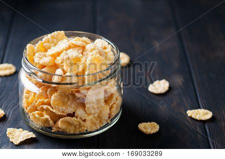 Close up of cornflackes in jar on dark wooden background selective focus horizontal