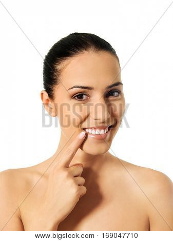 Dental health concept - beautiful woman pointing to her teeth