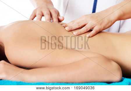 Woman having massage of body in the spa salon. Beauty treatment concept.