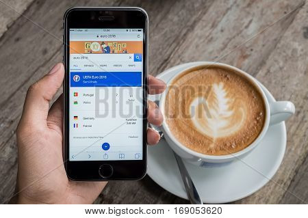 CHIANG MAI THAILAND - JULY 7 2016 : A man holding iphone showing screen shot of google search. Google is an American multinational corporation specializing in Internet-related services and products.