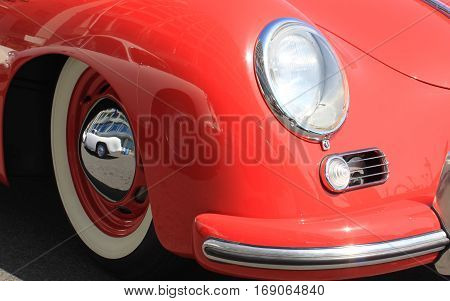 Close-up of headlights of white vintage car. Headlamp in classic luxury car. Headlight of vintage car close-up.