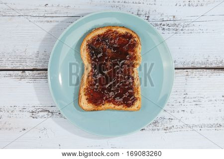 Typical Dutch apple syrup called Appelstroop on bread on wooden background