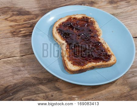 Typical Dutch apple syrup called Appelstroop on bread on wooden background