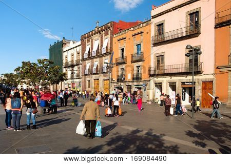 MEXICO CITY,MEXICO - DECEMBER 28,2016 : People and colorful old buildings next to the Zocalo at Mexico City historic center