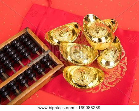 Chinese gold ingot and abacus mean symbols of wealth and prosperity.