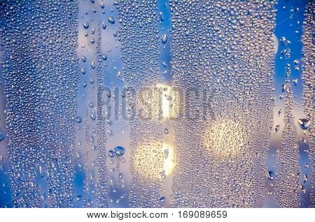Condenced water drops on a blurred background with lights