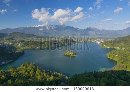 Panoramic view of Lake Bled from Little Osojnica Hill, at sunny day with beautiful clouds on background, Slovenia