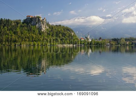 Lake Bled with the rocktop castle and St Martin church reflected in the water. Slovenia