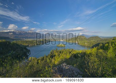 Panoramic view of Lake Bled from Ojstrica Hill, at sunny day with beautiful clouds on background, Slovenia