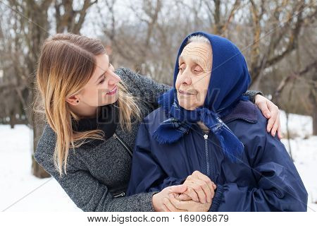 Picture of a happy elderly woman with her loving granddaughter