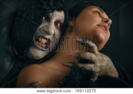 Ancient Monster Vampire Demon Bites A Woman Neck. Halloween Fantasy