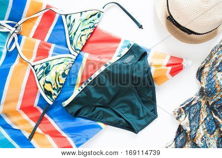 Overhead view of summer concept with bikini colorful beach umbella and girls accessories