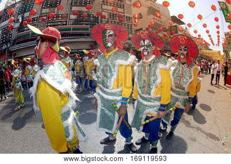 NAKHONSAWAN ,THAILAND - JANUARY 31,2017 : Unidentified fighting show of villager warriors ( Aung-Gor ) on the street in city during the Chinese New Year celebrations in Nakhonsawan Province,Middle of Thailand.
