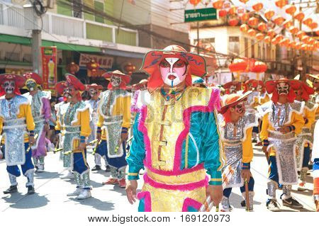 NAKHONSAWAN ,THAILAND - JANUARY 31,2017 : Unidentified fighting show of villager warriors ( Aung-Gor ) on the street in city during the Chinese New Year celebrations in Nakhonsawan Province,Middle of Thailand.