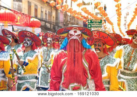NAKHONSAWAN ,THAILAND - JANUARY 31,2017 : Unidentified fighting show of villager warriors ( Aung-Gor ) on the street in city during the Chinese New Year celebrations in Nakhonsawan Province,Middle of Thailand.