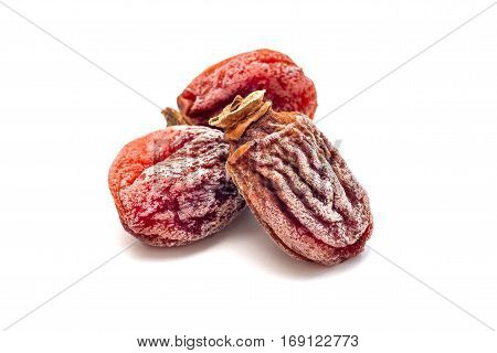 Several dried persimmon isolated on white background