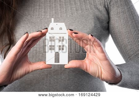 Architecture building real estate and property concept . Woman holding house or home maquette.