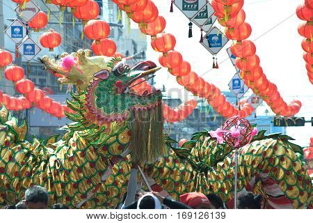 NAKHONSAWAN , THAILAND - JANUARY 31,2017 : Group Parade of Golden dragon show at Middle market in Nakhonsawan city during the Chinese New Year celebrations in Nakhonsawan Province ,Middle of Thailand.