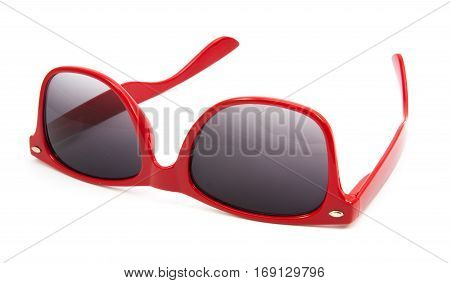 Beautiful red sunglasses on white background .