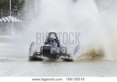 Naples Florida USA - March 3 2012: Swamp buggy coming out of turn throwing big roostertails