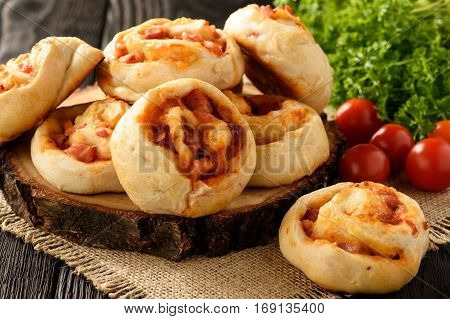 Pizza rolls with tomato sauce, mushrooms and cheese.