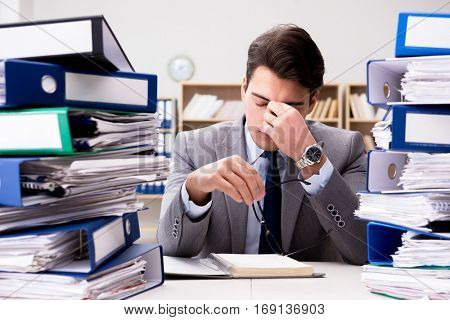 Busy businessman under stress due to excessive work