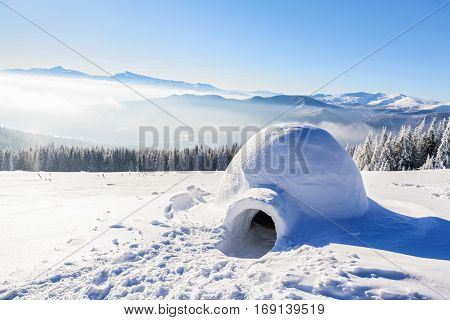 Marvelous huge white snowy hut igloo the house of isolated tourist is standing on high mountain far away from the human eye
