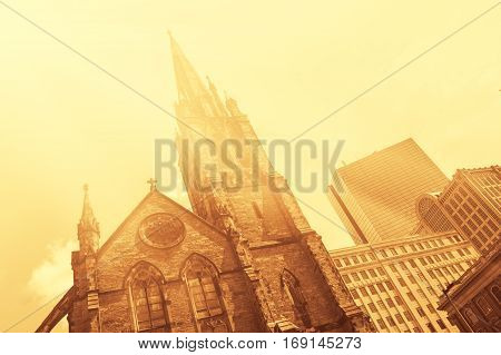 Old church in front of modern glass-and-steek buildings of Boston Downtown vintage look colorized with flare