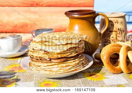 SAMARA RUSSIA - MARCH 13 2016: Appetizing fried pancakes and bagels during traditional russian Pancake Week