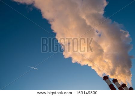 environmental pollution concept, pipes and smog on blue sky background
