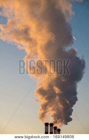 environmental pollution concept, pipes and smog on blue sky background