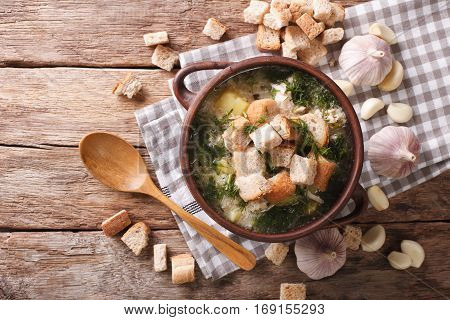 Soup With Garlic And Croutons Close-up In A Rustic Style. Horizontal Top View