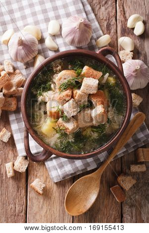 Delicious Garlic Soup With Croutons In A Bowl Close-up. Vertical Top View