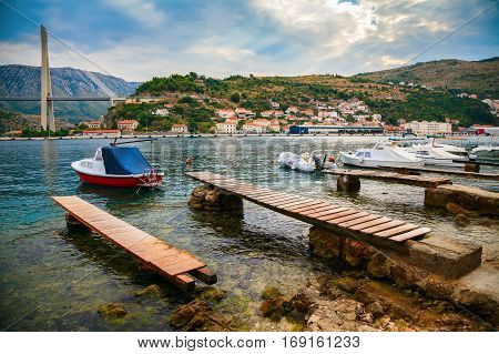 moored boats at the coast of Lapad with the view of the Tudjman Bridge in Dubrovnik Croatia