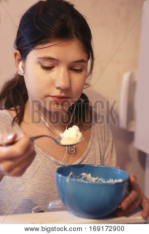 Teen Girl With Headphones Eat From The Fridge
