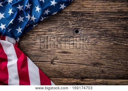 USA flag. American flag. American flag freely lying on wooden board. Close-up Studio shot. Toned Photo.