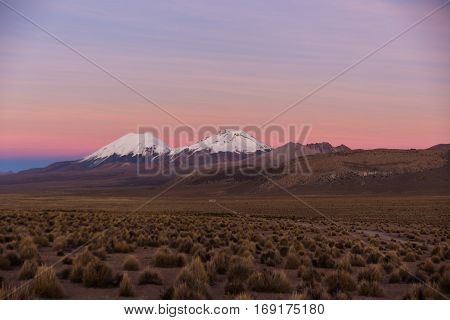 Sunset In Andes. Parinacota And Pomerade Volcanos.